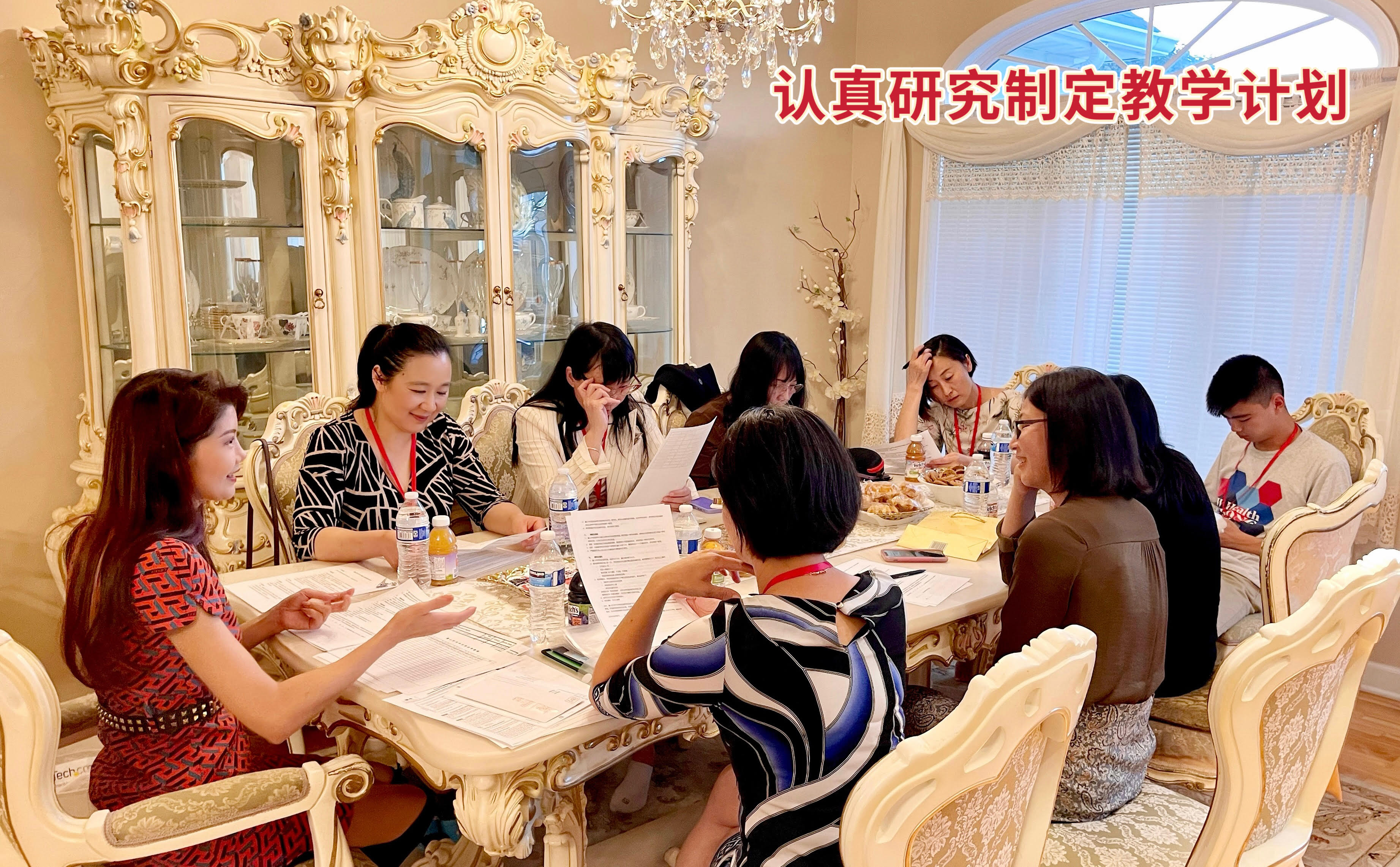 A group of people wearing face masks around a tableDescription automatically generated